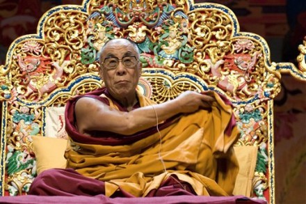 Tibetan spiritual and temporal leader His Holiness the Dalai Lama adjusts his robe at the beginning of a ceremony in the ice stadium of Lausanne, western Switzerland, Tuesday, Aug. 4, 2009. His Holiness the Dalai Lama is on a five day visit to Switzerland. (AP Photo/Keystone, Dominic Favre)