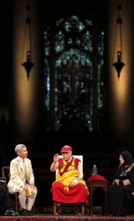 His Holiness the Dalai Lama flanked by his translator Geshe Thupten Jinpa, (L) and panelist Sakena Yacoobi,  (L) speaks during an interfaith dialogue at the Church of St. John the Divine on 23 May 2010 in New York City /Getty Images Photo