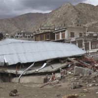 A collapsed building is seen after flash floods occurred in Leh/AP Photo