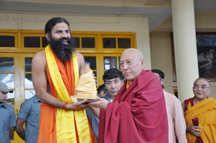 Swami Ramdev receives a souvenir from Kalon Tripa during a function at the main temple