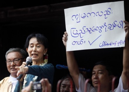 Aung San Suu Kyi addresses supporters outside her National League for Democracy party